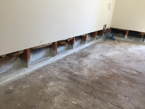 We sprayed the elastomeric along the bottom plate sections, and then went back over the sprayed areas with a 2-inch brush to touch up any areas we missed.
