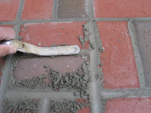 After the grout joints are packed full and have set up a bit, the author goes back and dresses the joints with a concave jointer. Pressing hard against the jointer as it is run over the joints packs the mortar tight and gives the top of the joint a neat, concave profile. 