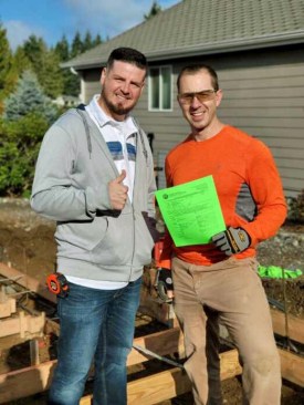 Thumbs up. The author (right) with his local building inspector and a completed inspection card.