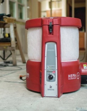 The BuildClean unit pulls air from all sides, first through a prefilter and then through a HEPA filter, before clean air is discharged thorough the port at lower left in the photo above. For lead-safe operations, this port must be  hooked up to a discharge hose to eject the filtered air outdoors.