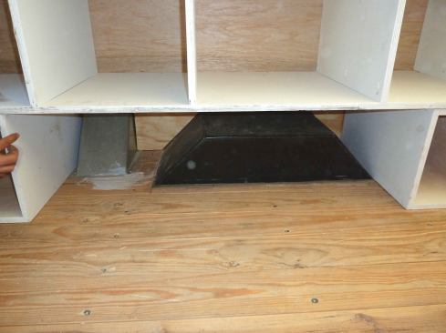 On both sides of the box, the storage cases rest on banks of drawers, which provide enough elevation for the casework to clear the wheel wells and the fuel-filler pipe cover.