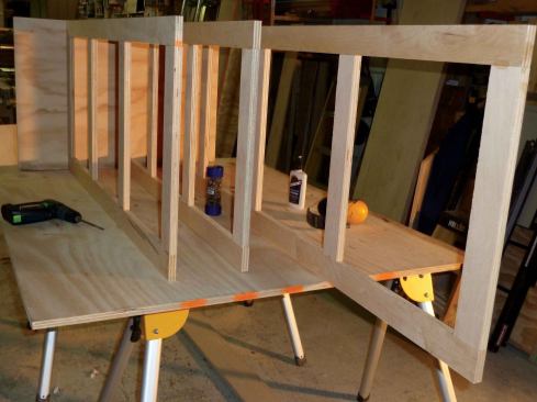 Partitions for this cabinet are ladder frames that we made in the shop and then pocket-screwed in place. If we should ever need to change the configuration of the cabinet, we would simply back out the screws, move the partition to its new location, and drive the screws back in.