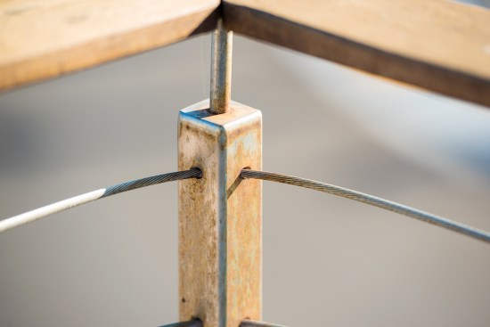 Besides being undersized, the original, single-corner posts required a sharp bend in the cable, which prevented proper tensioning.