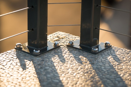 The posts are equidistant and located a minimum of 4 inches from their centers to the corner, which creates a soft, 45-degree cable bend ateach post.