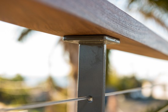 By upgrading from a 3⁄4-inch-thick to a full-2x4 ipe top rail, the author was able to eliminate the metal subrail typically used with aluminum and lighter-gauge stainless steel rail systems.
