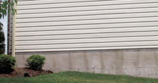Like all cladding, vinyl siding leaks. By design, it is made with weep holes to allow for drainage, but it needs a good drainage plane behind it to protect the wall. In this example, the secondary moisture barrier is doing its job, shedding enough water that wet spots are clearly visible underneath the vinyl siding.