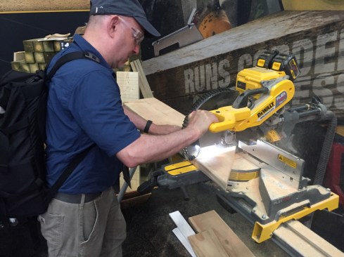 Here's contributing editor David Frane making a couple of cuts with the new 120V cordless sliding compound miter saw. It cut this 2x10 at 45 and 90 with no problem. Note the dual battery packs on top of the saw. When I gave this saw a try it seemed quite clear that it has some serious power - no noticeable difference from the AC version.
