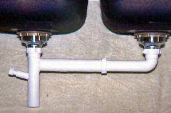 This less costly but improved drain configuration replaces the typical vertical standpipes — as well as their slip fittings — with screw-on elbows attached directly to the strainers. The only slip fitting is in a horizontal position, so it is less likely to leak.