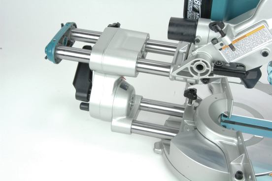 The elegant dual-slide mechanisms of the cordless Makita saw give it the same sliding range as the larger corded saws, but it rolls up into a more compact package. Keeping the arms short also serves to reduce deflection from downward forces on the cantilevered rails.