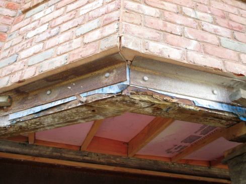 None of the brick and stucco exterior cracked from the lift except a small portion of the chimney base that we were unable to support. Everywhere else, my crews had bolted steel angle-iron to the sills when the brick was installed. As long as the building frame was well supported by the mover's steelwork, there was no risk to the cladding.