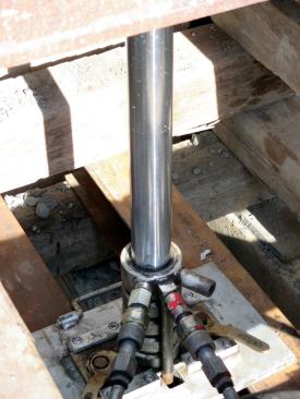 The hydraulic jacks have a throw of about 16 inches. We needed to go up to 10 feet 7 inches. To do this the lifter has to "jump the jacks." It's kind of the way crane operators will leapfrog their way up a skyscraper, lifting one crane over itself, and when that one's set, it pulls the lower one over itself. In this case, some extended jacks support the house, while others are backed off and their cradles stacked higher, so this set of jacks can be extended, and so forth.