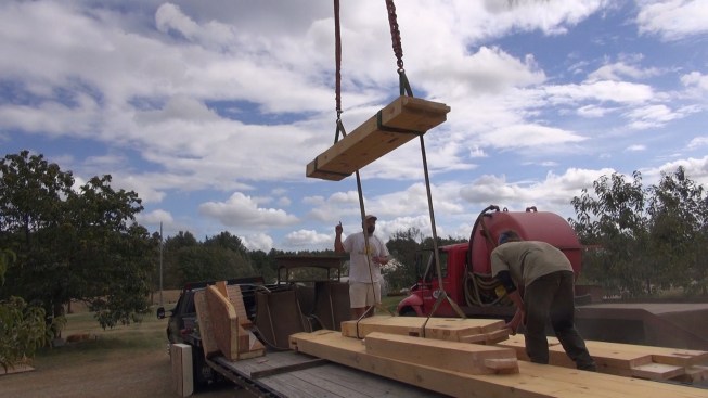 With the crane doing the heavy lifting, Chris and Toby re-stack the timbers onto the truck for transport back to the shop.
