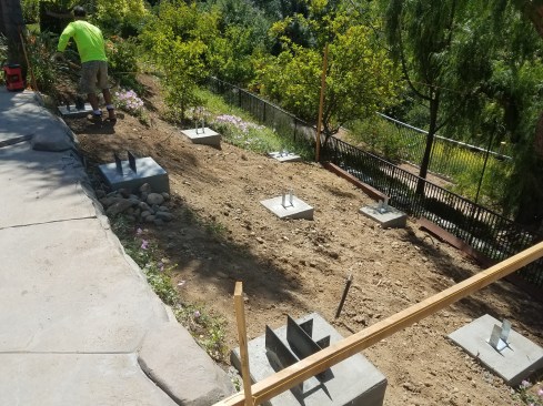 Metal hardware to connect the framing to the footings was embedded in the concrete during the pour.