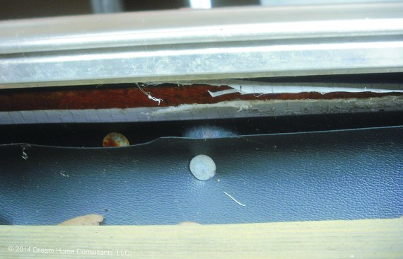 Flashing is often improperly installed underneath door thresholds.