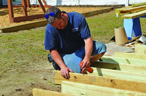 After the joists were installed, a simple string-and-pencil compass was used to lay out the deck’s curved edge.