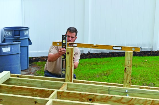 Along the high side of the deck, 4x4 posts support a bench, which serves a safety function in addition to providing seating.