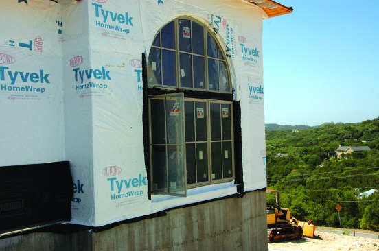 Driving by this site, the author stopped to look at the detailing on a large, recessed arch-top window. From  a distance, it was evident it wasn’t flashed well.