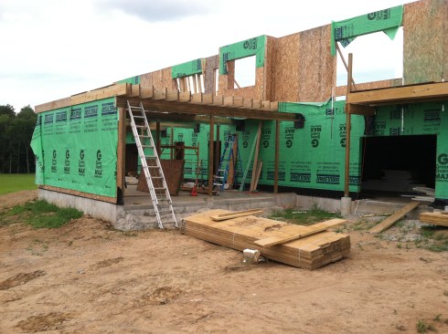 The beams are pitched 1⁄4 inch per foot for drainage, and support the roof deck’s 2x10 framing.
