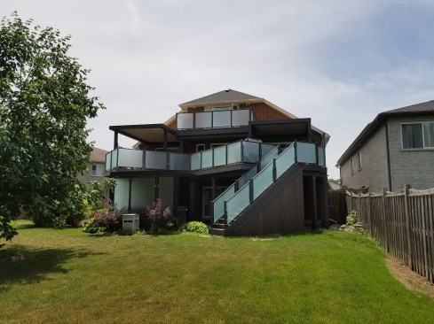 Opening things Up; I suggested adding 2 doors and an upper level deck. Our client is an accountant and her office is on the 3rd floor of the home. Adding a door with a small deck enables her to take her work outside on beautiful sunny days. People invest in a dream deck to enjoy  life. Another door was opened up to the master bedroom on the main deck. Glass 3 season room;  Beneath the smaller louvered roof on the main deck, glass walls will be added soon to create a very unique 3 season room. 