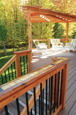 An occasional application of clear silicone caulk to the grout helps prevent water from penetrating this tile inlay and damaging the 2x6 cedar caprail.