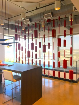 Several tools anc accessories were used thorughout the company's offices as art installations and interior design elements. This is a sort of sun-screen wall that diverts light throughout a large meeting area and in the stairwell beyond it. It's made of Hilti coring bits. 