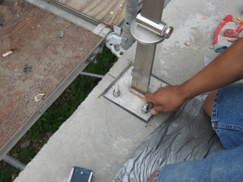 Next, the metal-post base plate is connected tothe bolts.