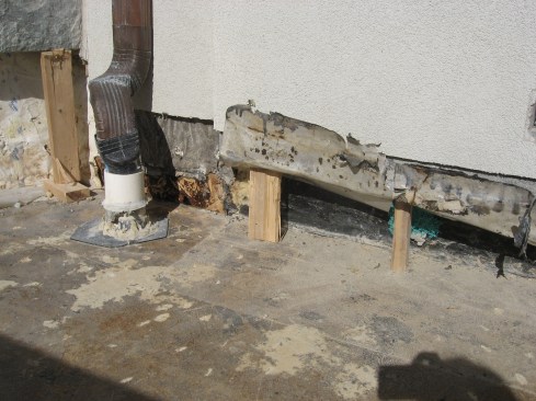 The joint where the rubber roofing met the masonry was seen to be compromised, and aluminum flashing behind the block  was corroded and leaky.