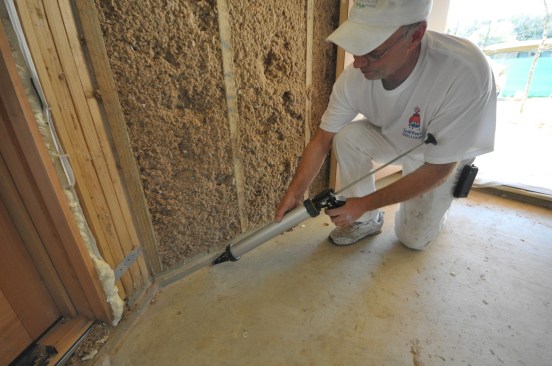 Bottom wall plates must be caulked or taped inside, and sealed with flexible flashing outside.