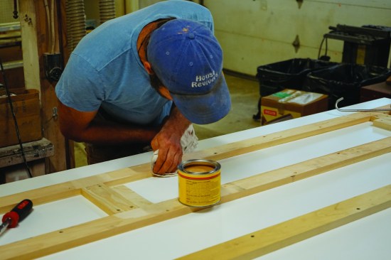 The author coats the edges of his wood form strips with paste wax.