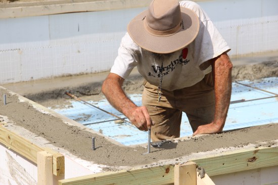 My helper took care of tamping the walls (our version of a vibrator), and together we placed the anchor bolts.