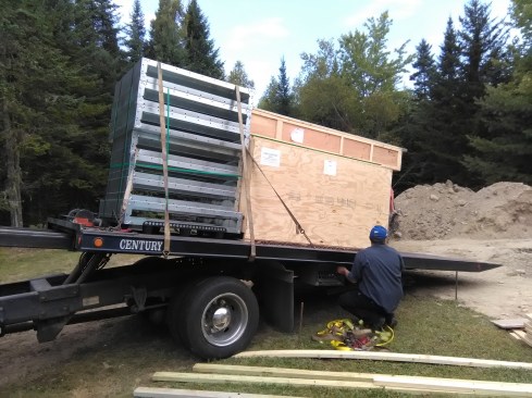 With the insulated foundation slab and walls ready, I had the pool panels delivered.