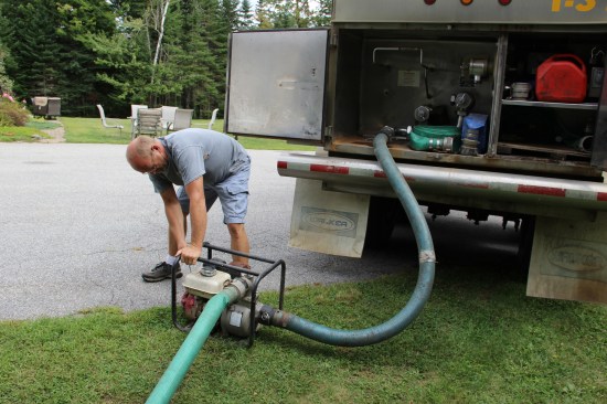 With the liner placed, I start filling the pool with a few inches of water. For this job, I trucked in 4,800 gallons of water.