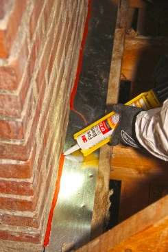 Jerome sealed the edges of the metal to the brick with sealant.