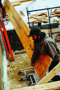 Engineered LVL material lets carpenters assemble high-capacity beams on site, using manageable pieces with uniform strength characteristics. Carpenter Matt Friel helped carry 28-foot pieces onto the home’s floor deck.