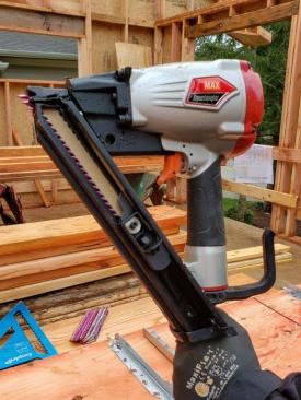 The Max SuperLocator positive placement nailer has a straight, compact magazine that holds 1 1/2-inch metal connector nails.