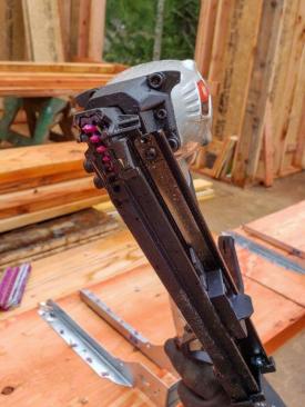Instead of a probe, the gun uses the tip of the nail to locate the hole in the hardware.