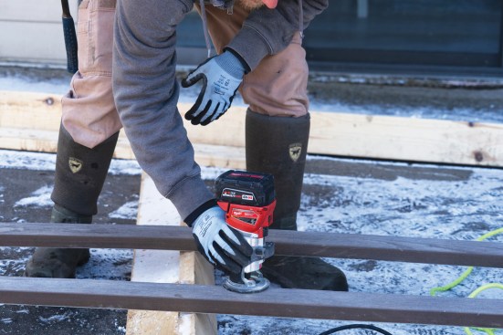 After ripping a board to width, a worker routs the cut edge to match the original profile and remove cut marks and any sharp edges.