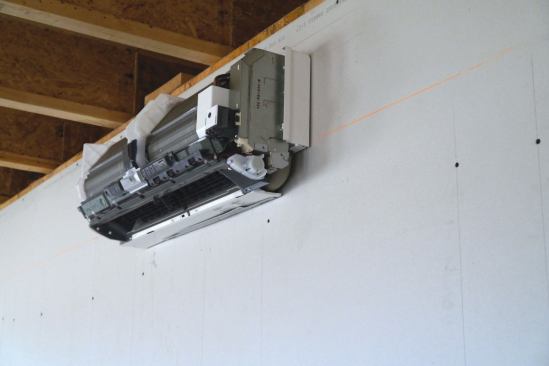 The indoor head of the minisplit hangs on a mounting plate and bracket.