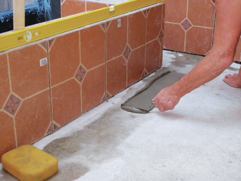 Trowel on a thin coating of Portland cement slurry to create an adhesive layer.