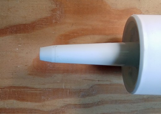 Two ways to cut the tip on the end of a tube of caulk:  Or, try a square cut (above); it is easier to control at a consistent angle, and delivers a healthier bead of caulk. By contrast, the long point of a single angled cut can drag through and deform the bead.