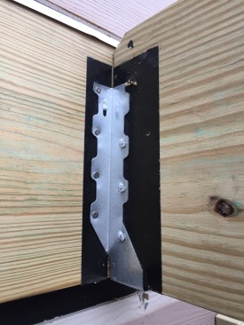 Though newer PT formulations aren’t as corrosive as ACQ-treated lumber, many builders still wrap joist ends with self-adhesive flashing tape prior to hardware installation.
