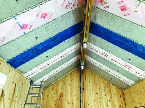 In each unsealed bay, the research team has installed different combinations of air-permeable cavity insulation, vapor-open and vapor-closed ceiling vapor retarders, air barriers, and diffusion ports to evaluate the complex set of variables acting on unvented roofs. (Photo courtesy Building Science Corporation)