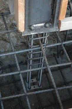 Bolt Brace.  A Bolt Brace at the embed end acts as a spreader and ensures the anchors will not sway independently while concrete is being poured, and will keep the anchors parallel and plumb. The rebar reinforcement shown is designed by the Engineer of Record for this project. Be sure to get the anchorage inspected prior to pouring concrete.