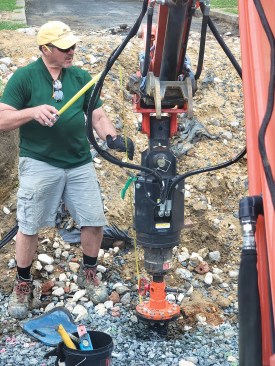To make sure that the elevations of the T-caps were all within 1/8 inch of each other, the author first used the string line for reference when installing the piers, then used a rotary laser to fine-tune them.