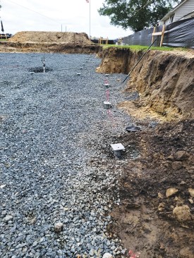 A total of 59 helical piers—each with a minimum bearing capacity of 15,000 pounds—were installed to support the grade beam footing.
