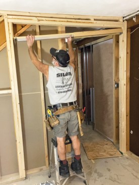 The frame-header end brackets have slots that allow them to slide down over the nail heads, making it easier to accurately locate the frame header.