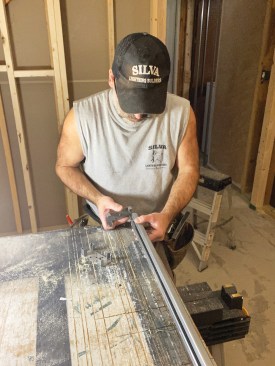Next, he inserted a floor plate into the ends of one of the two pairs of split steel studs.