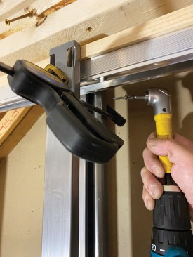 Tight clearances between the new door opening and an existing wall required a right-angle drill to drive some of the screws.