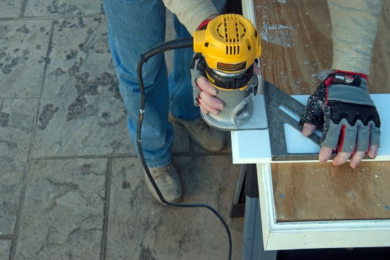 Longer lengths of PVC trim require a movement joint, which the author creates by first cutting a matching shiplap profile on the end of each board with a router.