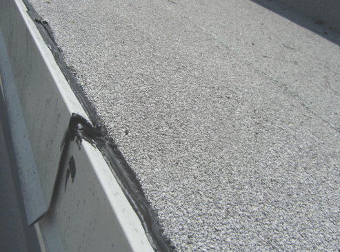 Critical low-slope details. Metal edges will move with temperature differences.